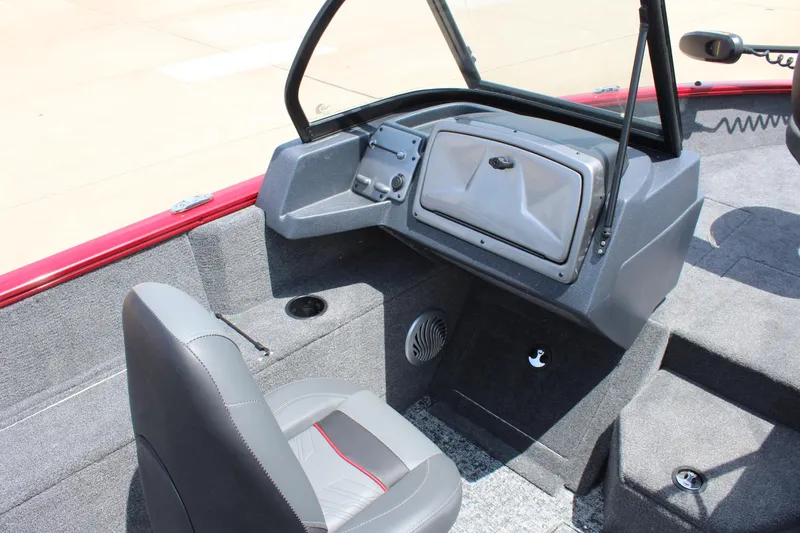 Slide: The Image of 2025 Tracker Pro Guide V-175 Combo boat interior with gray seating and dashboard. - 11