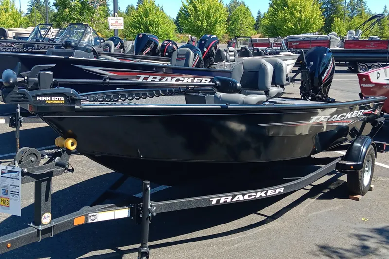 The Image of 2025 Tracker Super Guide V-16 T boat on display in a dealership lot. - 0