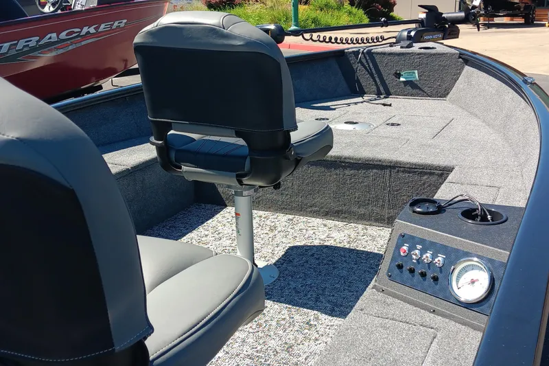 Slide: The Image of 2025 Tracker Super Guide V-16 T boat interior with seating and control panel. - 2