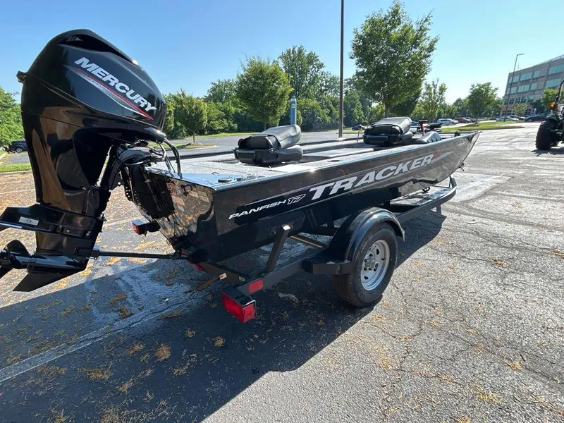 Slide: The Image of 2025 Tracker Panfish 17 boat with Mercury engine on a trailer in a parking lot. - 3