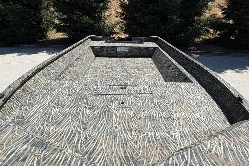 Slide: The Image of 2025 Tracker Grizzly 2072 Utility boat with camouflage pattern, parked outdoors. - 19