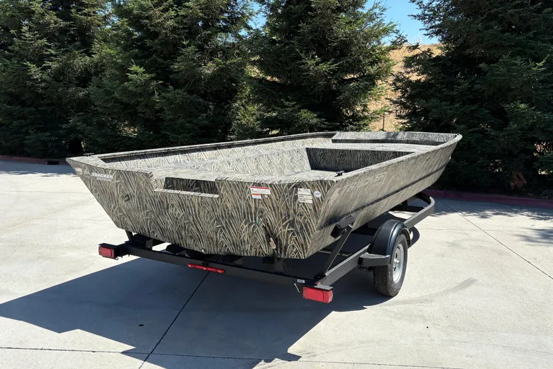 Slide: The Image of 2025 Tracker Grizzly 2072 Utility boat on trailer, parked outdoors. - 10