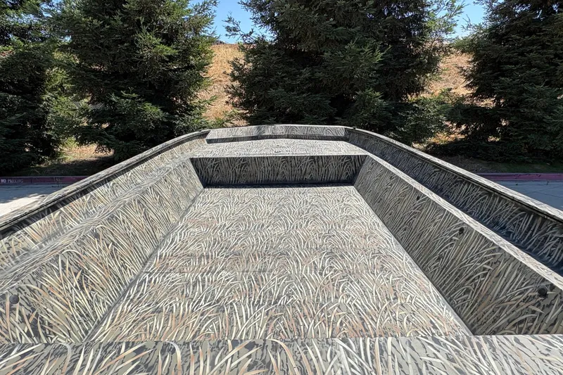 Slide: The Image of 2025 Tracker Grizzly 2072 Utility boat with camouflage interior, surrounded by trees. - 16