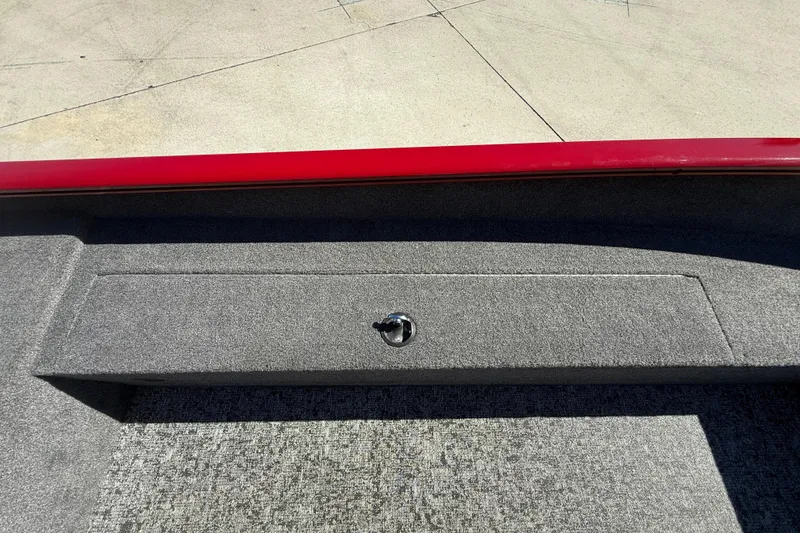 Slide: The Image of 2025 Tracker Super Guide V-16 T boat interior with red trim and carpeted storage compartment. - 20