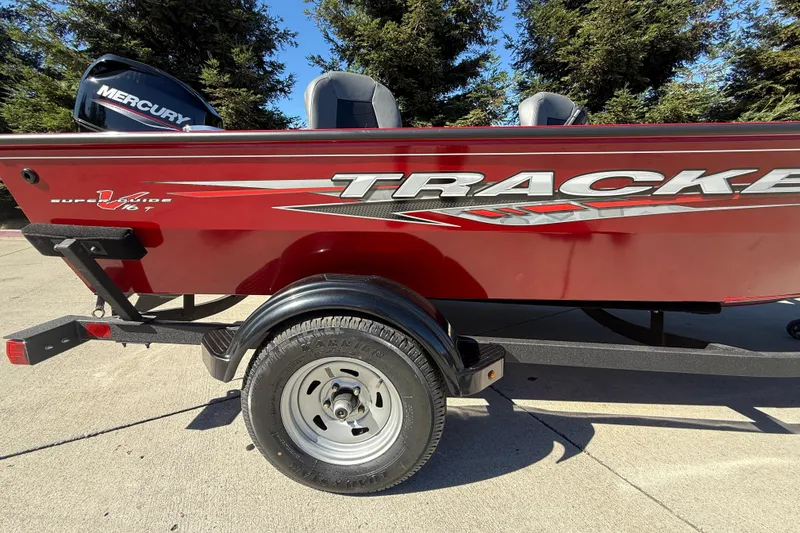 Slide: The Image of Red 2025 Tracker Super Guide V-16 T boat on trailer, featuring Mercury engine. - 7