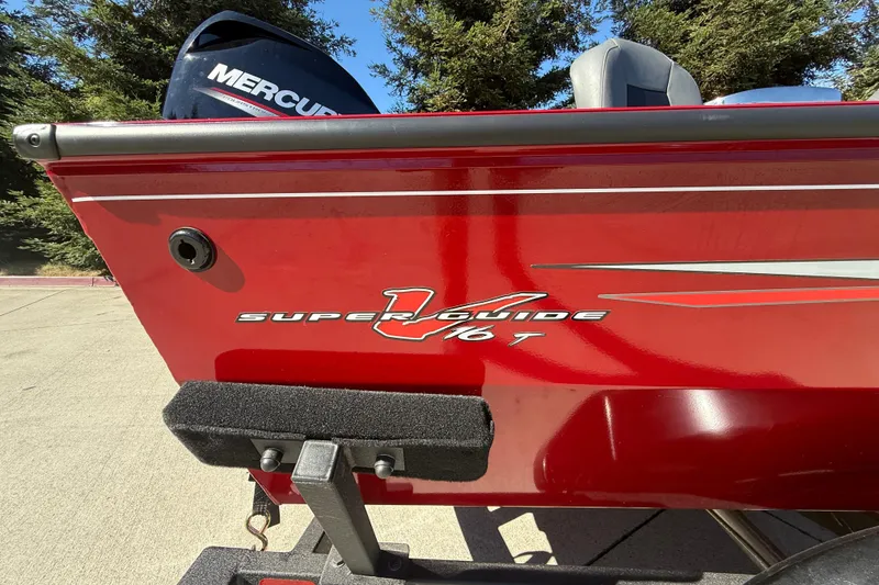 Slide: The Image of 2025 Tracker Super Guide V-16 T boat in vibrant red with Mercury engine. - 8