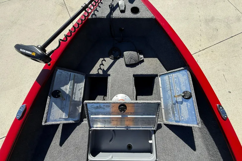 Slide: The Image of 2025 Tracker Super Guide V-16 T boat interior with storage compartments and trolling motor. - 13