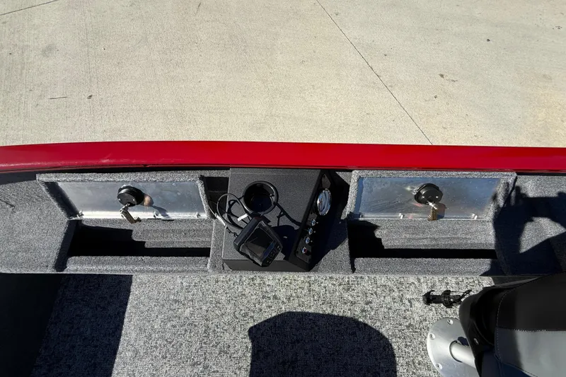 Slide: The Image of 2025 Tracker Super Guide V-16 T boat dashboard with controls and storage compartments. - 23