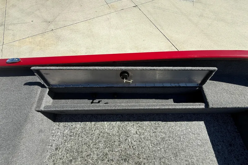 Slide: The Image of 2025 Tracker Super Guide V-16 T boat storage compartment with open lid, showcasing interior space. - 19