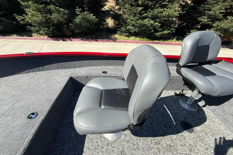 Slide: The Image of 2025 Tracker Super Guide V-16 T boat seats, gray upholstery, outdoor setting. - 17
