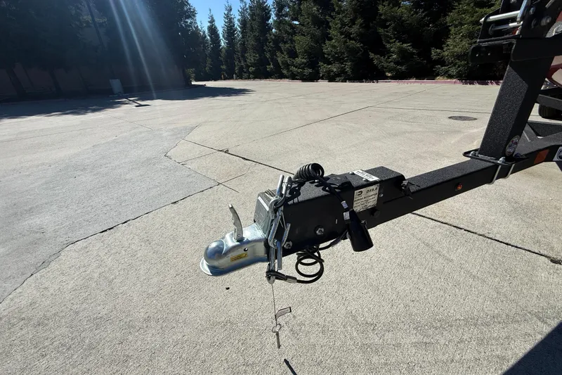 Slide: The Image of Trailer hitch of 2025 Tracker Super Guide V-16 T on concrete surface. - 22