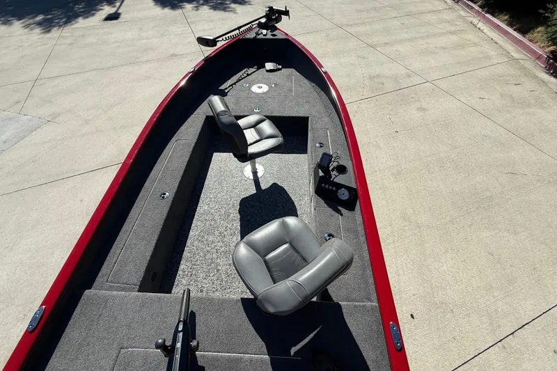Slide: The Image of 2025 Tracker Super Guide V-16 T boat interior with seating and control panel. - 16