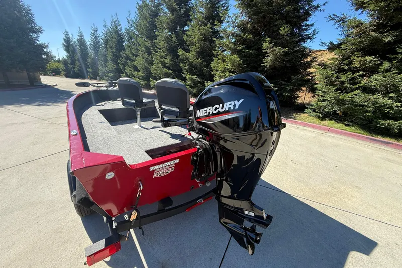 Slide: The Image of Red 2025 Tracker Super Guide V-16 T boat with Mercury outboard motor. - 6