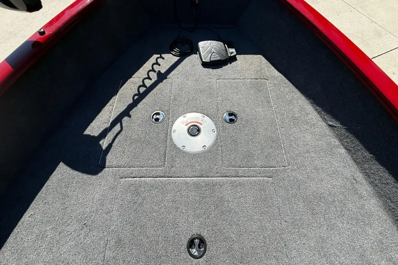 Slide: The Image of 2025 Tracker Super Guide V-16 T boat deck with carpet and pedal controls. - 18