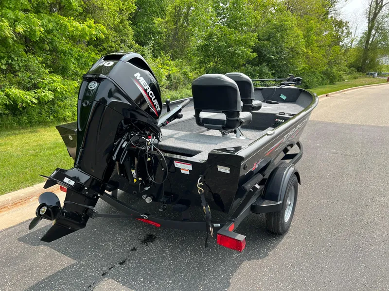 Slide: The Image of 2025 Tracker Super Guide V-16 T boat with Mercury engine on a road. - 4