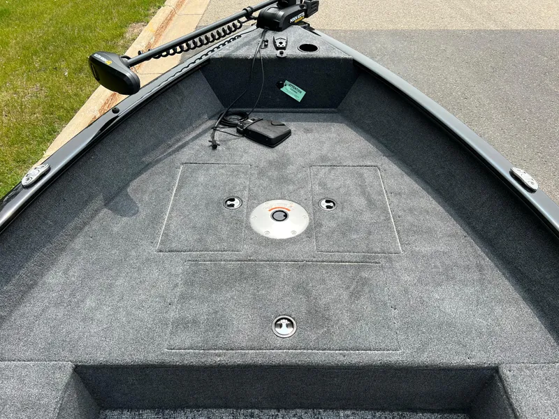 Slide: The Image of 2025 Tracker Super Guide V-16 T boat interior with gray carpet and mounted equipment. - 5