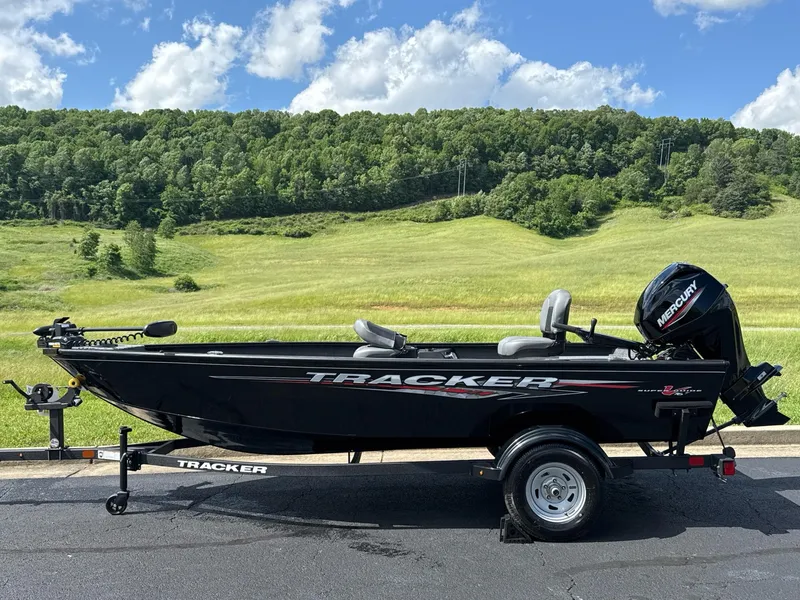 The Image of 2025 Tracker Super Guide V-16 T boat on trailer, scenic countryside background. - 0