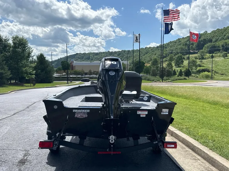 Slide: The Image of 2025 Tracker Super Guide V-16 T boat on trailer, scenic background with flags. - 3