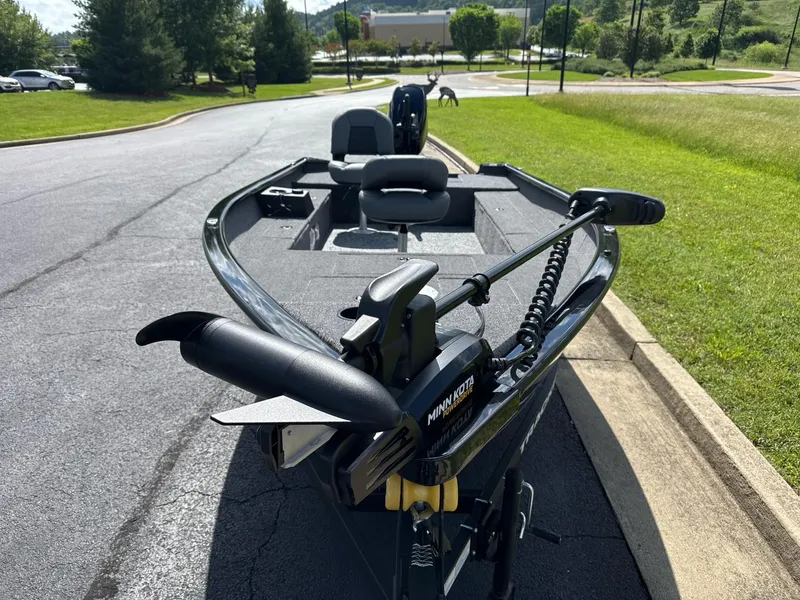 Slide: The Image of 2025 Tracker Super Guide V-16 T boat with Minn Kota trolling motor on a sunny day. - 5