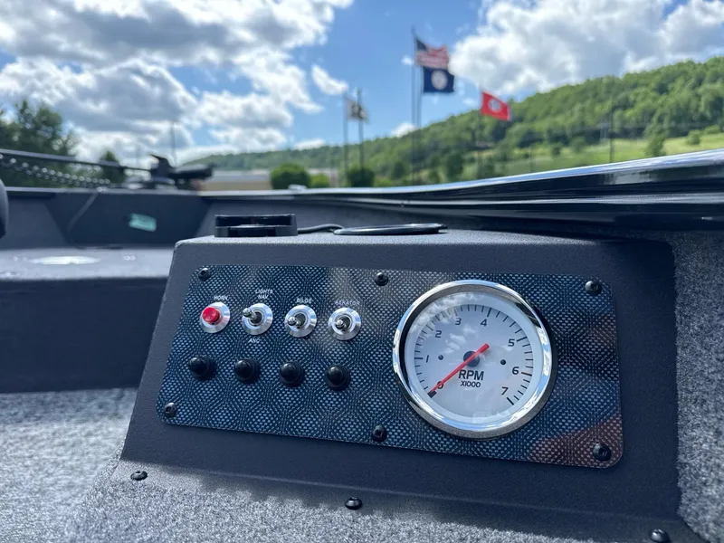 Slide: The Image of Dashboard of 2025 Tracker Super Guide V-16 T boat with RPM gauge and control switches. - 7