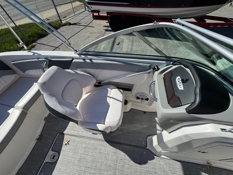 Slide: The Image of 2020 Chaparral 19 SSi OB boat interior with steering console and seating. - 13
