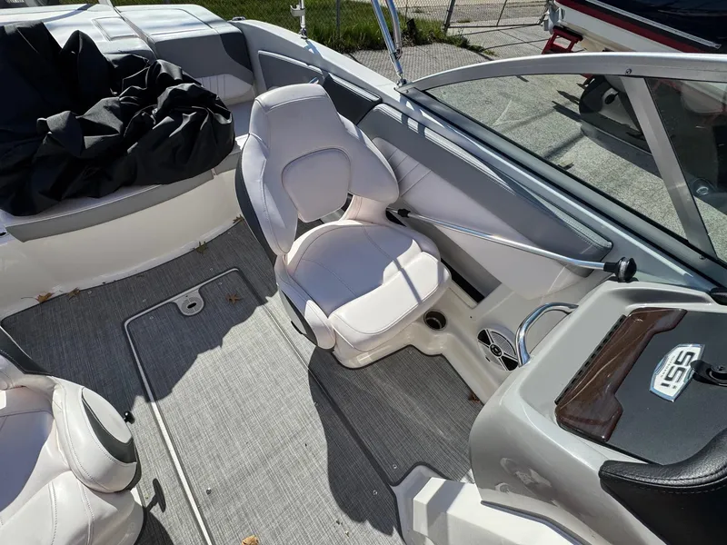 Slide: The Image of 2020 Chaparral 19 SSi OB boat interior with white seating and gray flooring. - 16