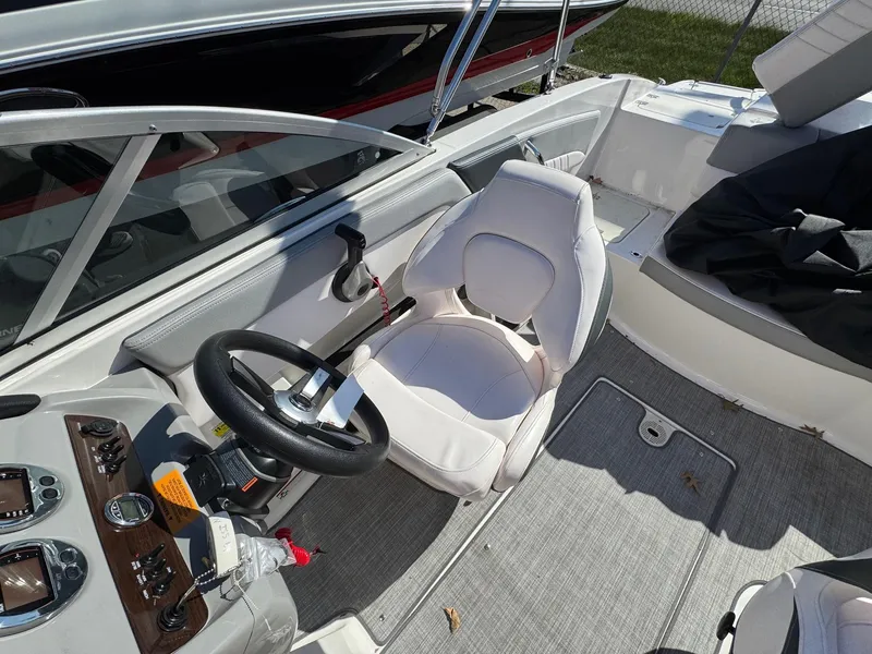 Slide: The Image of 2020 Chaparral 19 SSi OB boat interior with steering wheel and seating. - 17