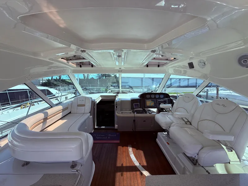 Slide: The Image of Luxurious interior of 2009 Sea Ray 48 Sundancer yacht with white seating and panoramic windows. - 15