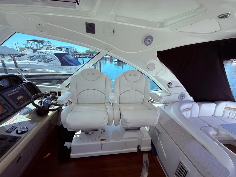 Slide: The Image of Interior of a 2009 Sea Ray 48 Sundancer yacht with luxurious white seating. - 17
