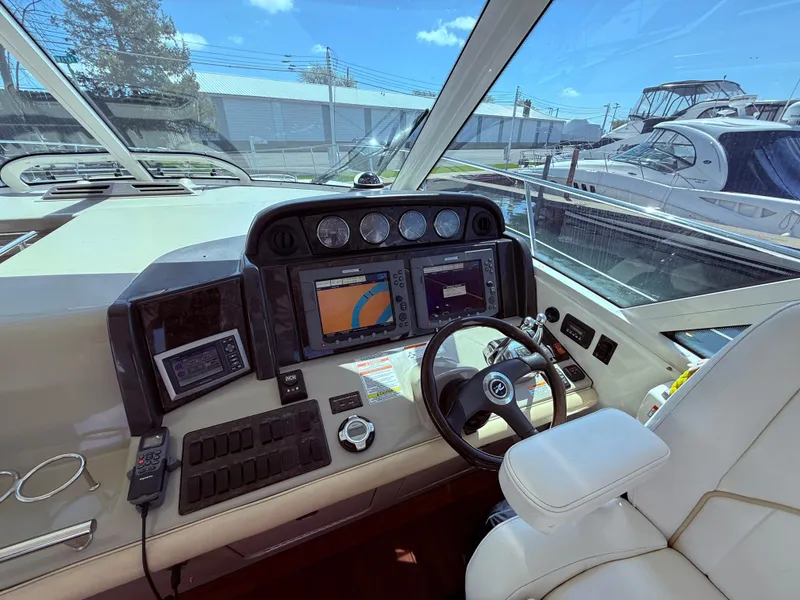 Slide: The Image of Helm of 2009 Sea Ray 48 Sundancer with navigation equipment and steering wheel. - 18