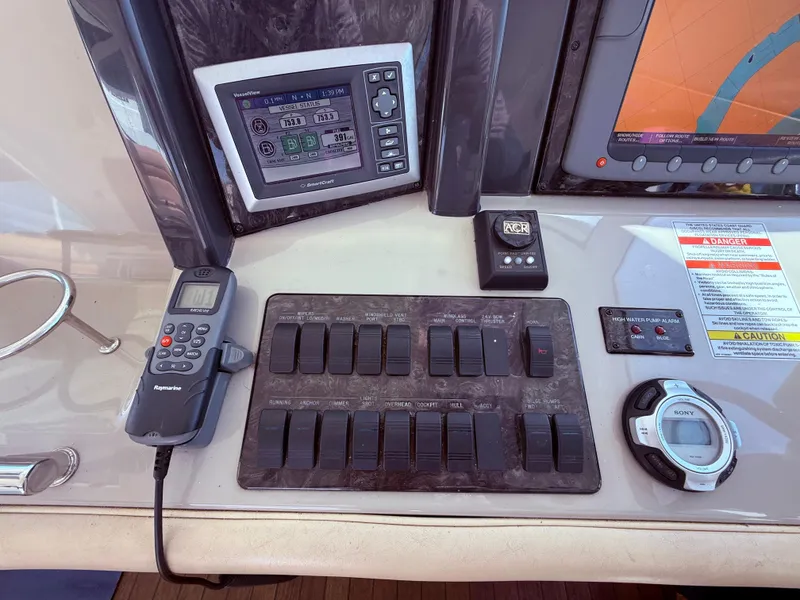 Slide: The Image of Control panel of a 2009 Sea Ray 48 Sundancer yacht with navigation and switch controls. - 19