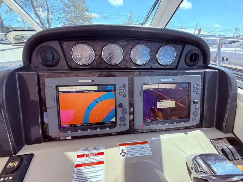 Slide: The Image of Helm of 2009 Sea Ray 48 Sundancer with dual navigation displays and gauges. - 21