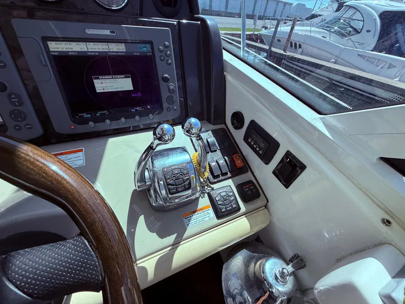 Slide: The Image of Control panel of a 2009 Sea Ray 48 Sundancer yacht with navigation equipment. - 22