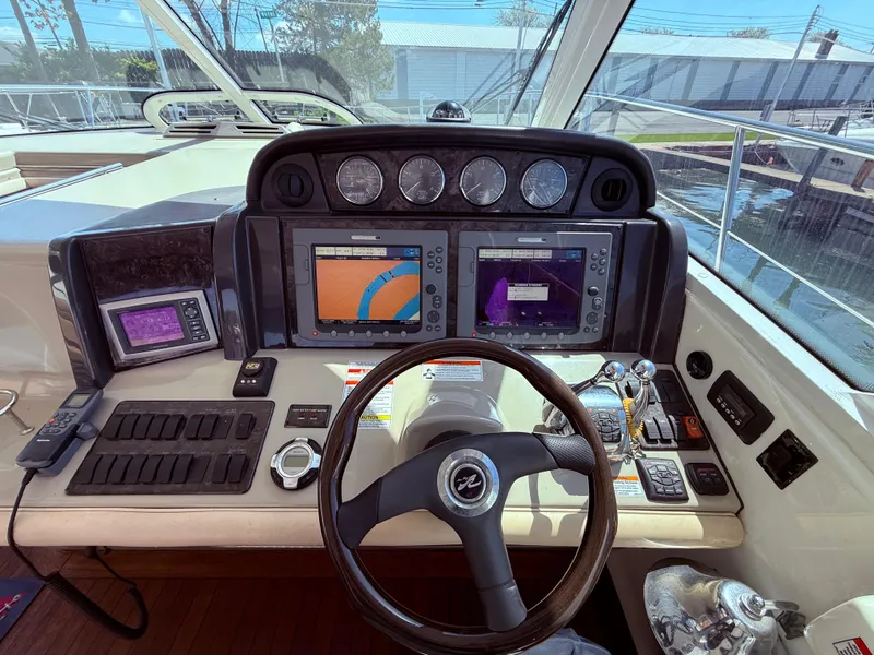 Slide: The Image of 2009 Sea Ray 48 Sundancer helm with navigation screens and controls. - 23
