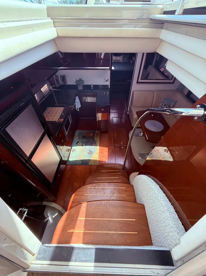 Slide: The Image of Interior view of 2009 Sea Ray 48 Sundancer yacht, featuring elegant wood finishes and modern amenities. - 24