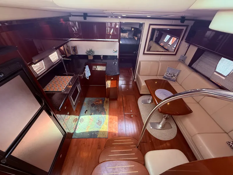 Slide: The Image of Luxurious interior of 2009 Sea Ray 48 Sundancer yacht with elegant seating and modern kitchen. - 25