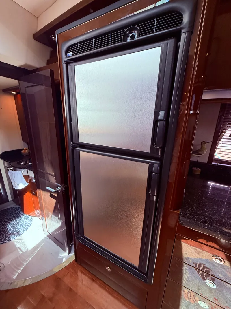 Slide: The Image of 2009 Sea Ray 48 Sundancer yacht interior with modern refrigerator. - 29