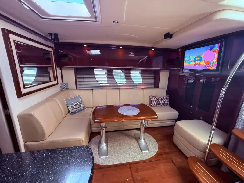 Slide: The Image of Luxurious interior of 2009 Sea Ray 48 Sundancer yacht with plush seating and TV. - 30