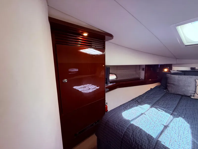 Slide: The Image of Interior cabin of 2009 Sea Ray 48 Sundancer yacht with bed and wooden cabinetry. - 34