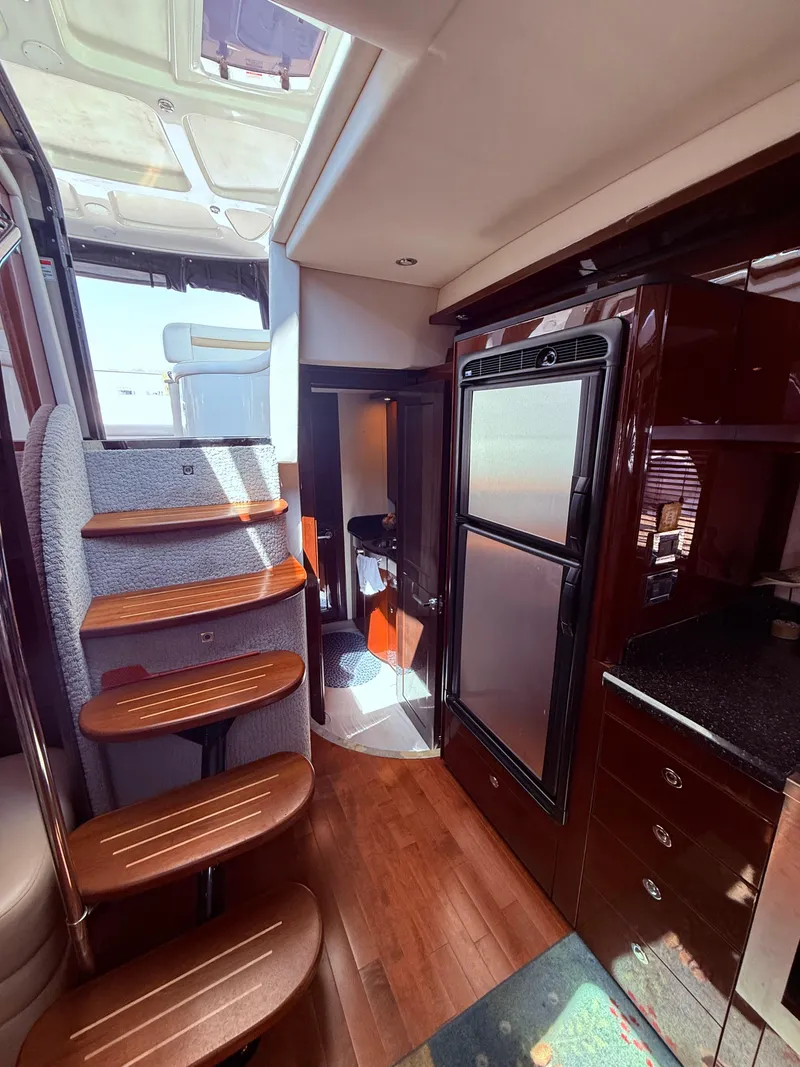 Slide: The Image of Interior of 2009 Sea Ray 48 Sundancer yacht with wooden stairs and modern kitchen. - 38