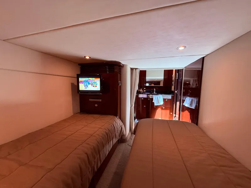 Slide: The Image of Interior cabin of 2009 Sea Ray 48 Sundancer yacht with twin beds and TV. - 41