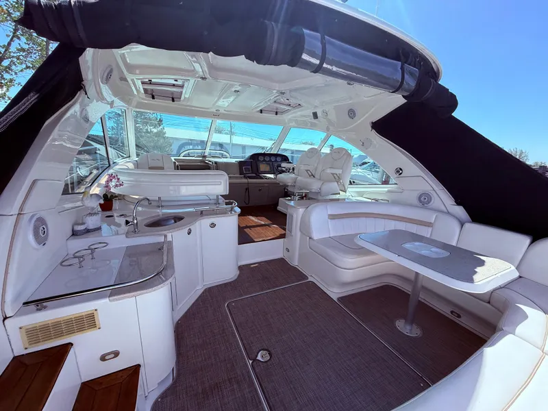 Slide: The Image of Luxurious 2009 Sea Ray 48 Sundancer yacht interior with seating and kitchenette. - 8
