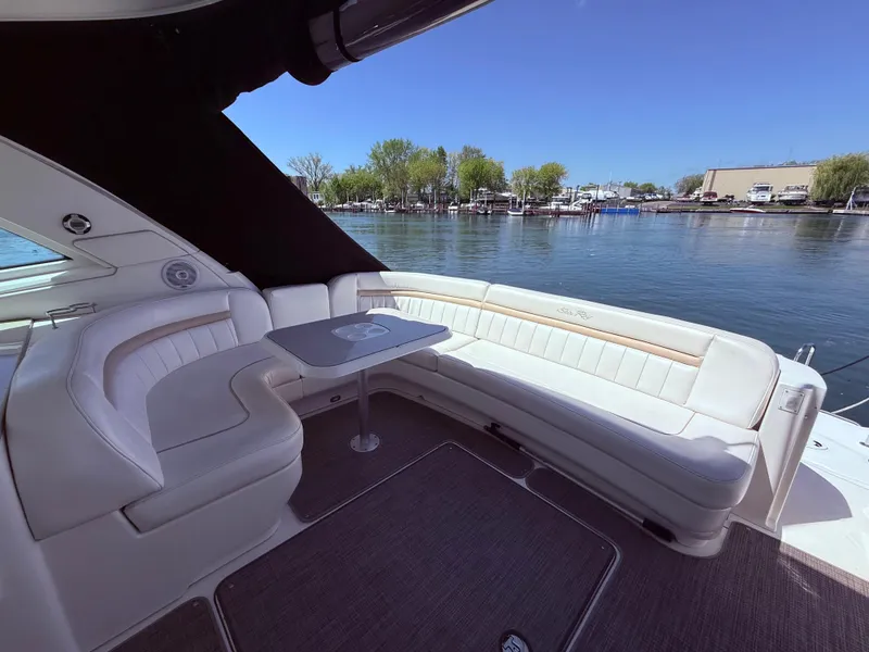Slide: The Image of Luxurious seating area on a 2009 Sea Ray 48 Sundancer yacht, overlooking serene waters. - 9