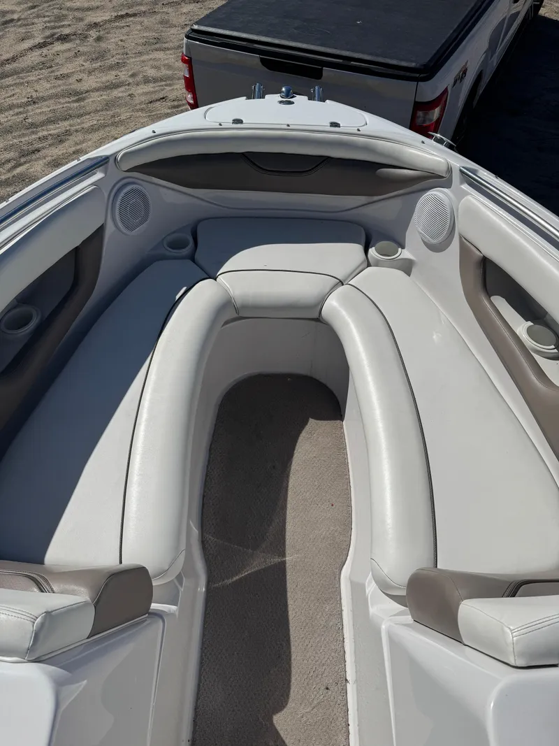 Slide: The Image of 2004 Four Winns 250 Horizon boat with spacious seating and modern design. - 11