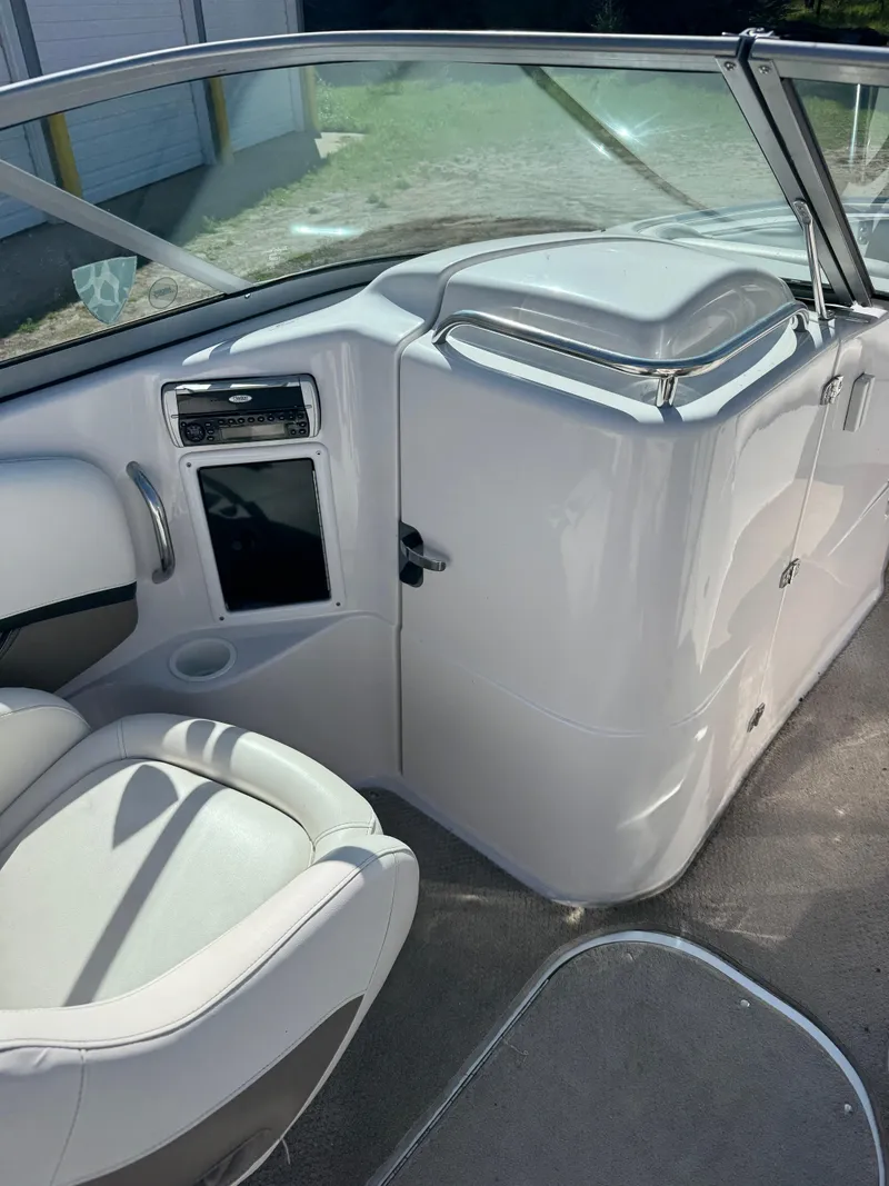 Slide: The Image of 2004 Four Winns 250 Horizon boat interior with white seating and dashboard. - 16