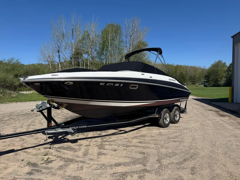 Slide: The Image of 2004 Four Winns 250 Horizon boat on trailer, parked outdoors on a sunny day. - 3