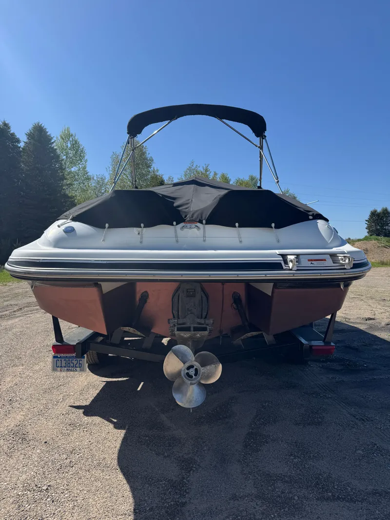 Slide: The Image of 2004 Four Winns 250 Horizon boat with canopy, parked on a sunny day. - 5