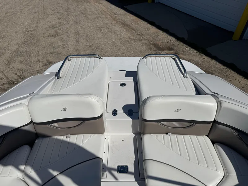 Slide: The Image of 2004 Four Winns 250 Horizon boat interior with white leather seating and metal handles. - 6