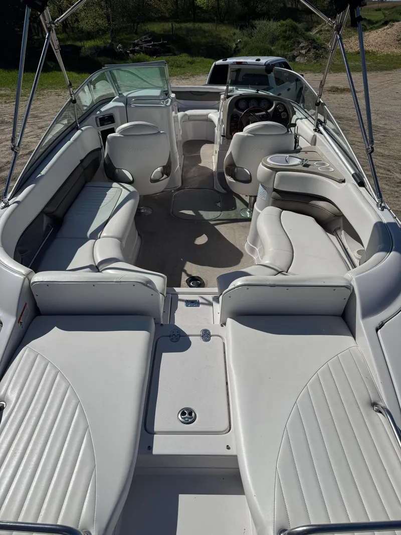 Slide: The Image of 2004 Four Winns 250 Horizon boat interior with white seating and steering console. - 7