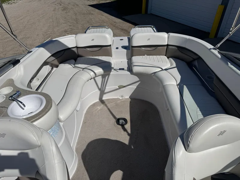 Slide: The Image of 2004 Four Winns 250 Horizon boat interior with white seating and a small sink. - 8